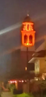 Illuminated tower glowing in the night sky.