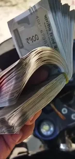 Close-up of Indian currency notes held in hand.