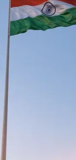 Indian flag waving against a blue sky.