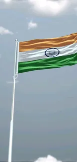 Indian flag fluttering in blue sky background.