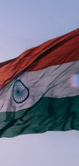 Waving Indian flag in bright sky.