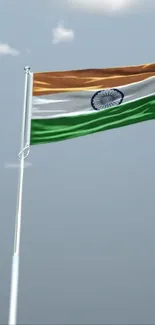 Waving Indian flag against a clear blue sky.