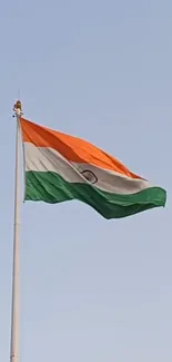 Indian flag waving against a clear blue sky.