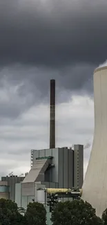 Industrial power plant with cloudy sky and steam emissions.