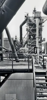 Monochrome industrial structure with metal beams and pipes.