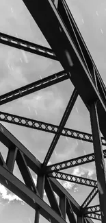 Black and white industrial steel beams against a cloudy sky.