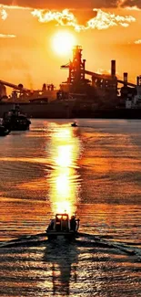 Vibrant orange sunset reflecting on water with industrial backdrop.