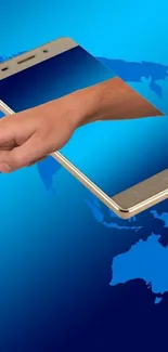 Hand through smartphone on a world map background.