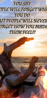 Inspirational quote on beach driftwood with sunset backdrop.