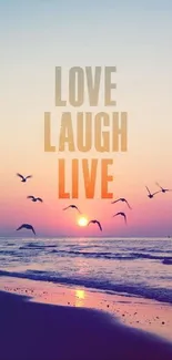 A sunset over a beach with seagulls and words 'Love Laugh Live' in the sky.