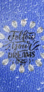 Blue textured wallpaper with 'Follow Your Dreams' quote in center.