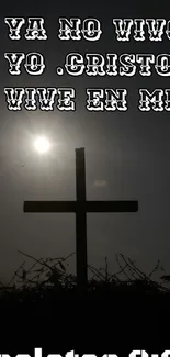 Silhouette of a cross with Bible verse in Spanish and heart icon.