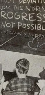 Vintage chalkboard with inspiring quote in classroom setting.