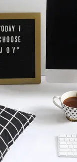 Modern desk setup with message board and coffee cup.