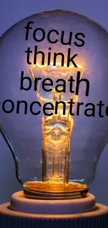 Inspirational light bulb with motivational words on a blue background.