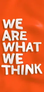 Orange wallpaper with motivational text saying 'We Are What We Think'.