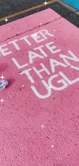 Pink pavement with motivational quote in white.