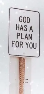 Motivational street sign saying 'God has a plan for you,' on a light gray background.