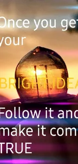 Motivational lightbulb against a sunset with inspiring quote.