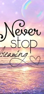 Inspirational wallpaper with a sunset and 'Never stop dreaming' quote.