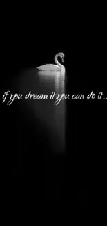 Black and white swan with inspirational quote on wallpaper.