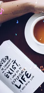 A cozy setup with tea, flowers, and a book on a wooden table.