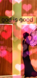 Angel silhouette next to wooden cross with 'god is good' text.