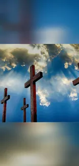 Mobile wallpaper of crosses against a blue cloudy sky.