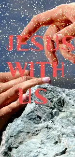 Hands reaching out over a rock with 'Jesus With Us' written.