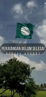 Flag waving under a bright blue sky with lush green landscape.