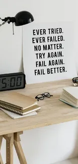 Minimalist desk with motivational quote, clock, and books.