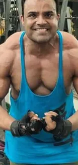 Muscular man in blue tank top working out in the gym.