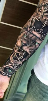 Detailed arm tattoo with lion and compass design.