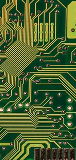 Close-up of a green circuit board pattern with yellow pathways and connections.