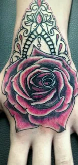 Intricate rose tattoo design on hand with bold colors.