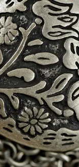 Intricate metal floral design with raised texture.
