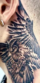 Intricate owl neck tattoo with detailed feathers.