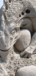 Intricate sand dragon sculpture on the beach.