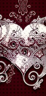 Intricate silver heart on dark red background mobile wallpaper.