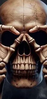 Intricate artwork of a skull with bones on a phone wallpaper.