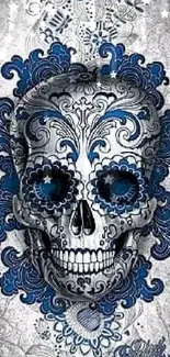 Intricate skull with blue floral designs on a gray background.