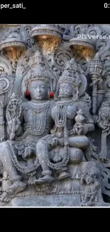 Stone relief of intricately carved deities with detailed adornments.