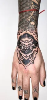 Intricate tattoo design on a hand with artistic flair.