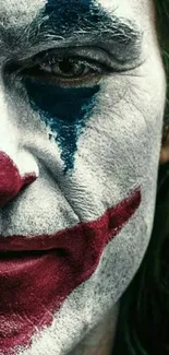 Close-up of a clown face with red and blue makeup.