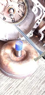 Sword piercing a gearbox above metallic components.