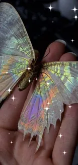 Iridescent butterfly resting on a hand with vibrant holographic colors.