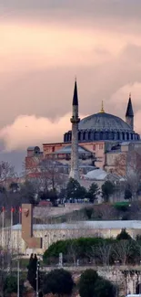 Hagia Sophia at sunset with Istanbul skyline under a colorful sky.