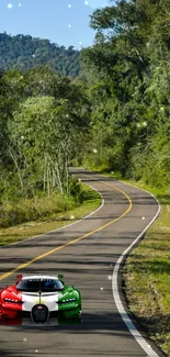 Italian sports car on a winding road in a lush green forest.