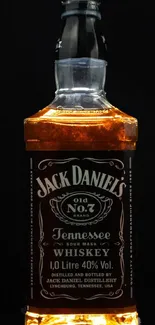 Jack Daniel's whiskey bottle on dark background.