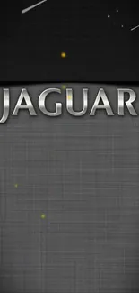 Jaguar logo on textured gray background with subtle metallic accents.